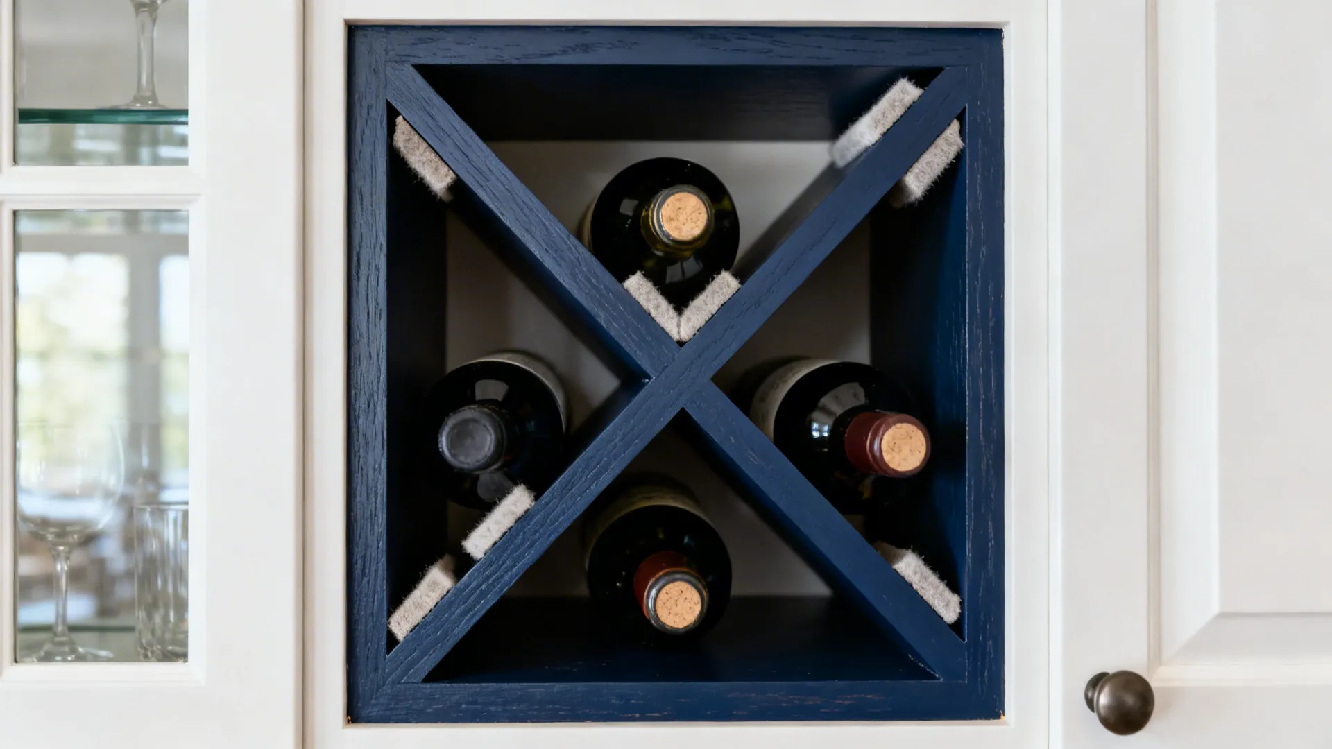 Close-up of a navy-painted diagonal X-grid wine rack retrofitted into an upper cabinet.
