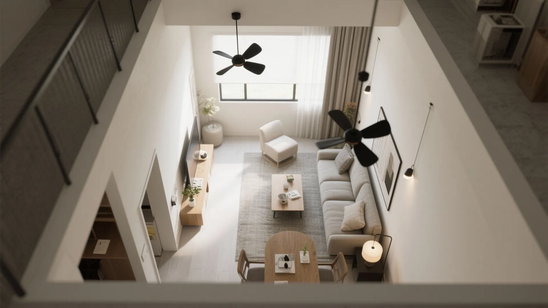 Top view of a bright open living room featuring two black fans and neutral furniture