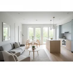 Bright open plan living area with grey sofa wooden kitchen island and light blue cabinets