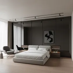Modern bedroom with white bed black mirrored sliding closet doors grey chair and wooden floor