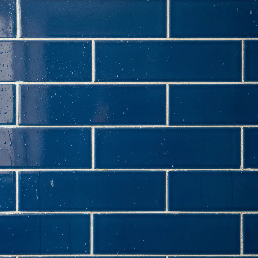 close view of blue tile bathroom wall showing grout staining contrast