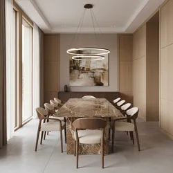 Spacious dining area with long marble table wooden chairs circular ceiling lights and wood wall panels