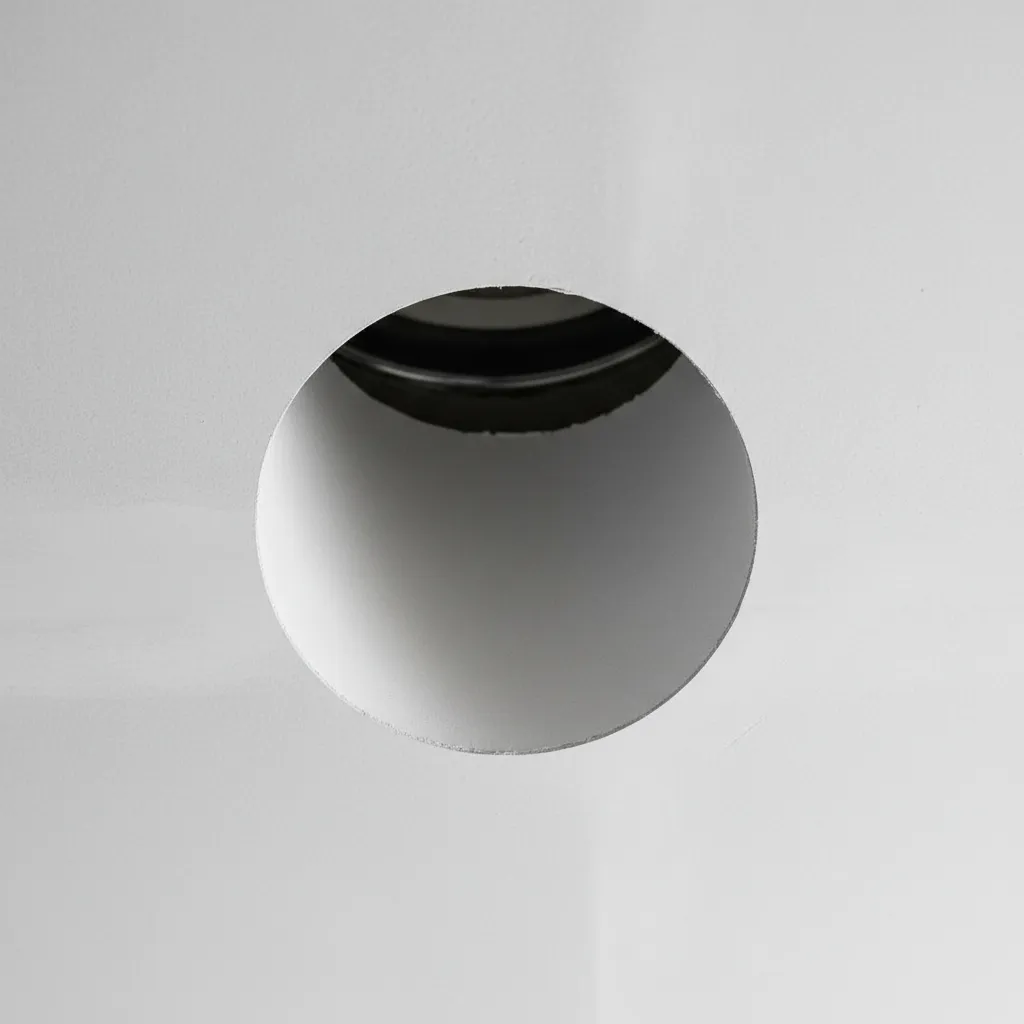 Clean circular drywall cutout for recessed lighting installation