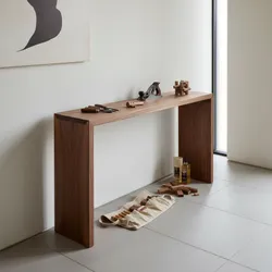 Slim wooden table with woodworking tools on top and a tool bag on the floor