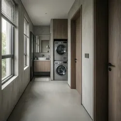 Modern narrow hallway with stacked laundry machines in wood cabinet next to windows and bathroom