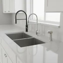 Comparison of three different kitchen faucet styles on a white marble countertop with double sink