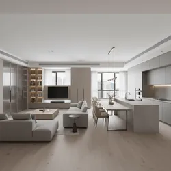 Modern open living room with grey sofas and kitchen island next to wooden dining table