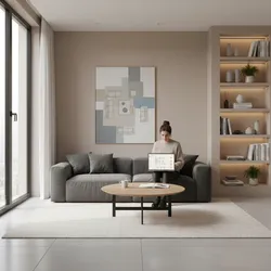 Woman sitting on sofa using laptop to create room layout in a modern living room