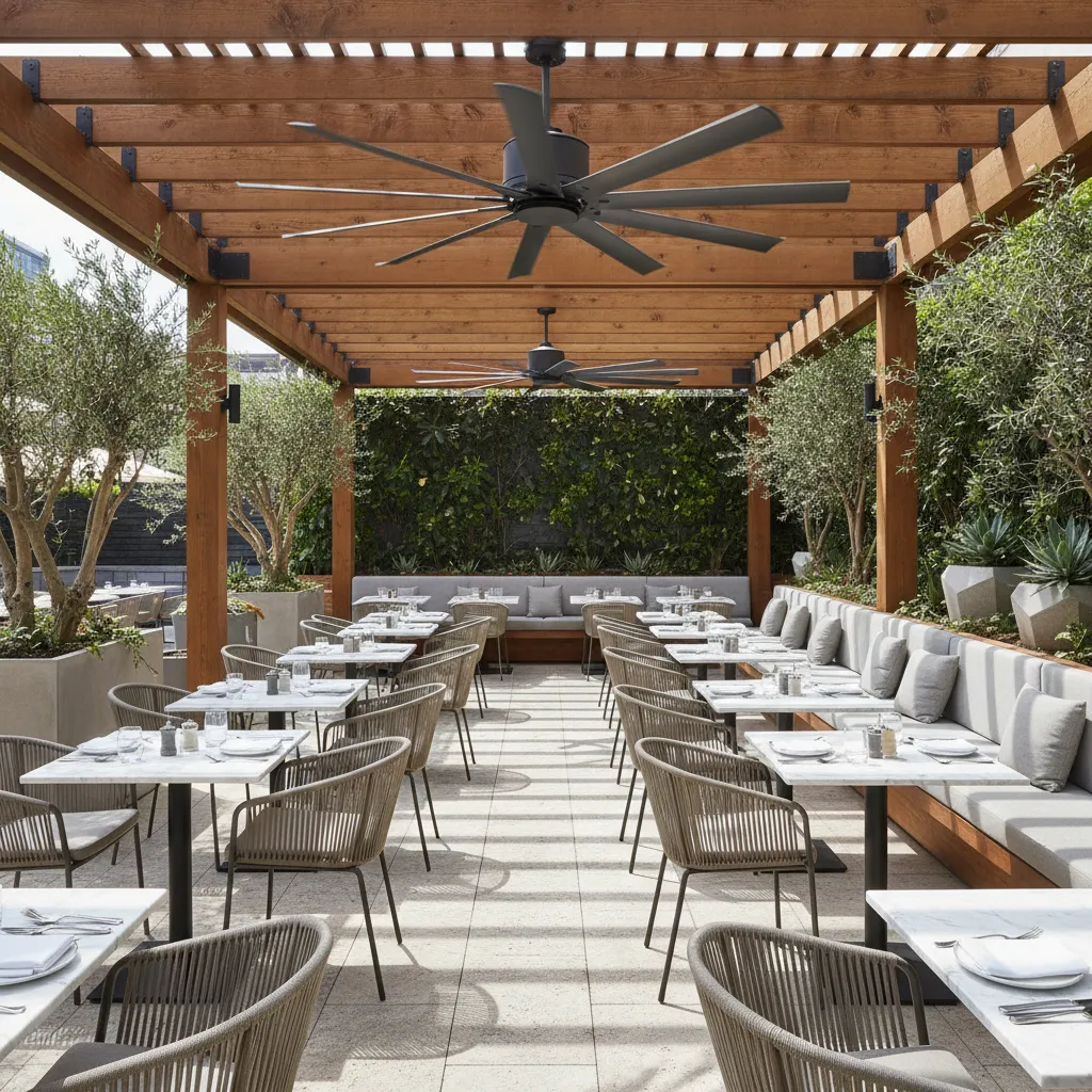 Restaurant patio seating area with large outdoor ceiling fan above dining tables