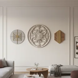 Three decorative wall art pieces hanging on white wall panels in a modern living room