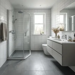Modern bathroom featuring white wall tiles grey floor tiles glass shower and white floating cabinet